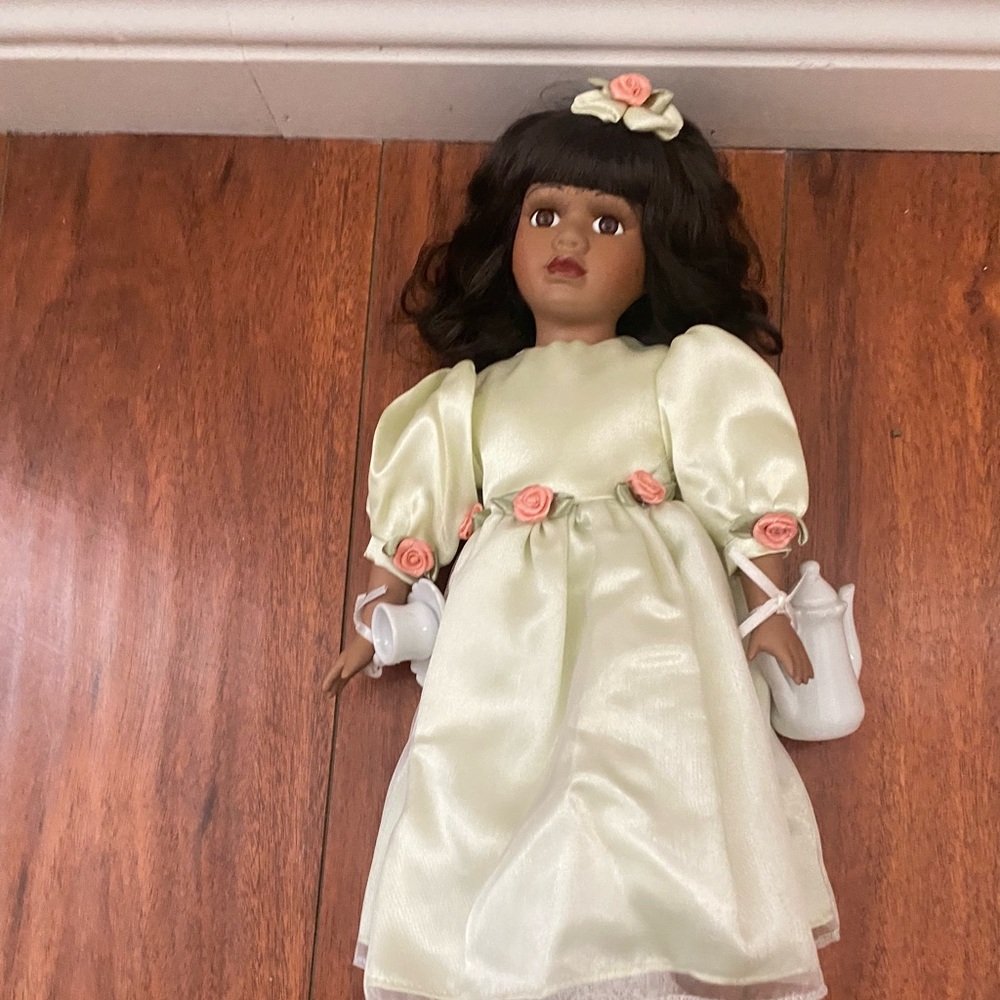 Black porcelain doll on stand